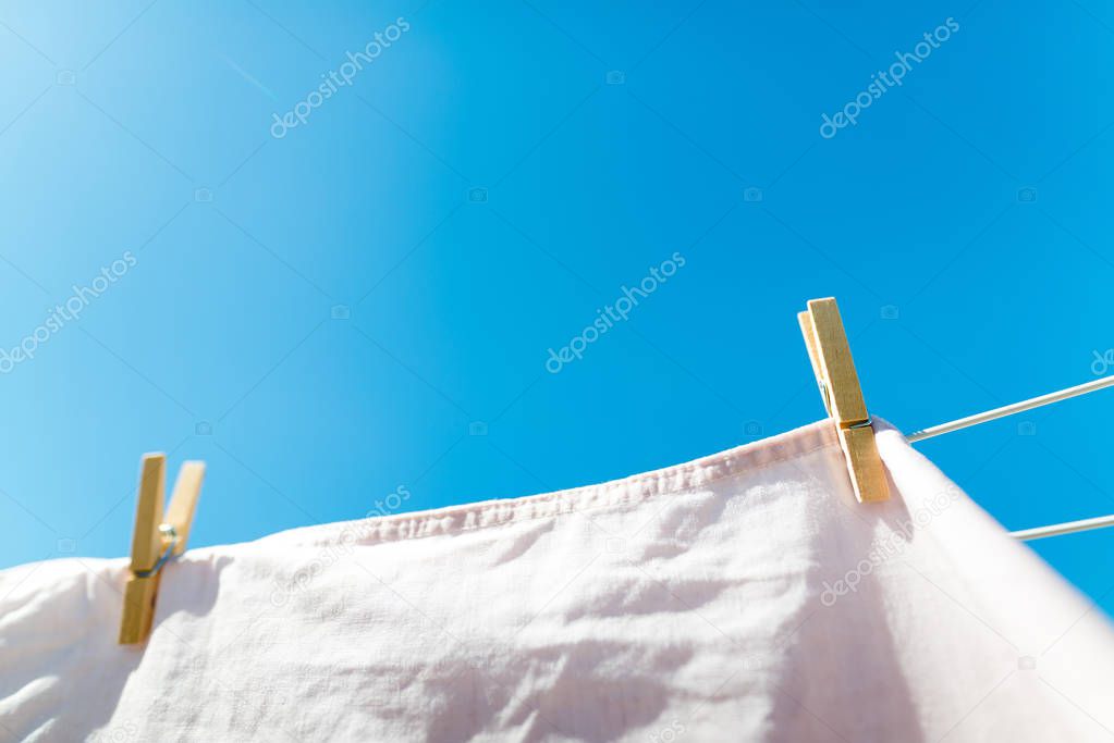 Bed sheet drying on a rope outside