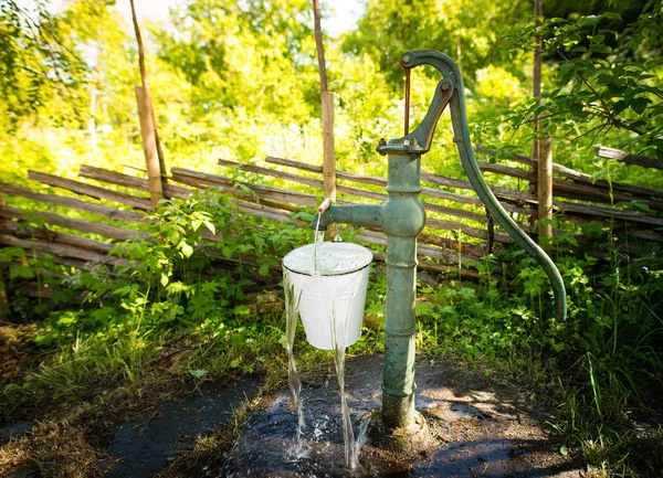 Old hand water pump outside in the garden — Stock Photo, Image