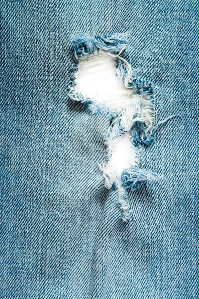 White hole in blue denim jeans — Stock Photo, Image