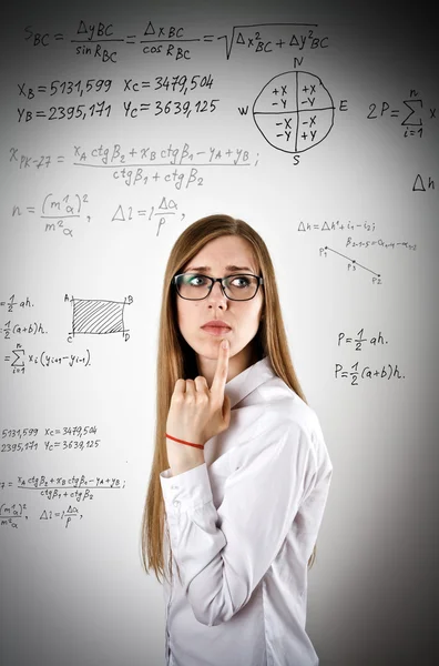 Woman in white is solving equation — Stock Photo, Image