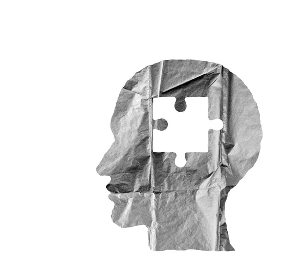 Crumpled paper shaped as a human head and puzzle on white. — Stock Photo, Image