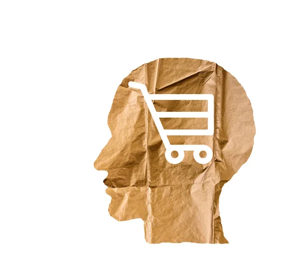 Crumpled paper shaped as a human head and shopping cart on white — Stock Photo, Image