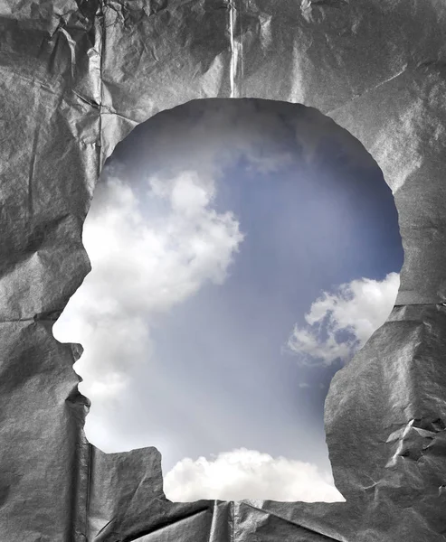 Buruşuk kağıt bir insan kafası şeklinde. Hea içinde bulutlu gökyüzü