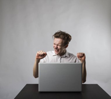 Young happy man with laptop. Success concept.