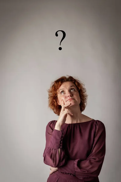 Red-haired woman and Question Mark. Stockfoto