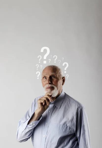 Old man and question marks. Confused old man. — 스톡 사진