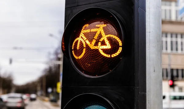 Traffic light for cyclists. Yellow light for bycicle lane on a t