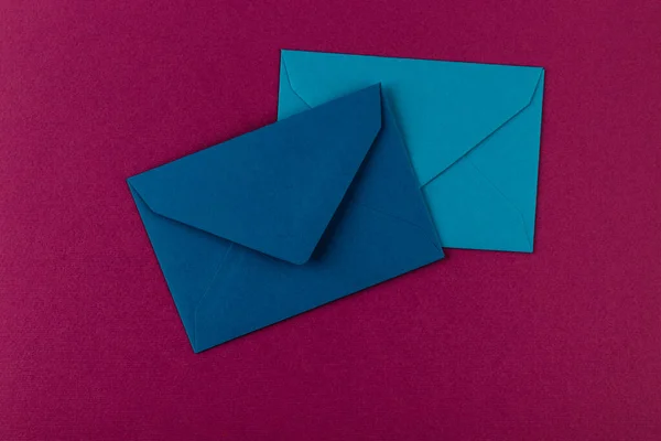 Colorful envelopes on a purple background. Mail envelopes on the table.