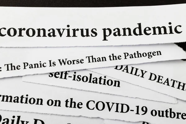 Coronavirus breaking news headline clippings from various newspapers reporting on the deadly disease. Coronavirus outbreak and COVID-19 crisis concept. Text. Macro view.