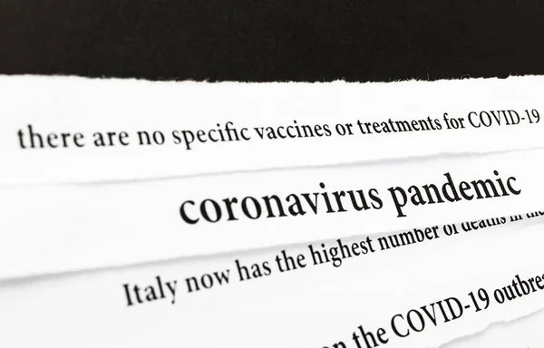 Coronavirus breaking news headline clippings from various newspapers reporting on the deadly disease. Coronavirus outbreak and COVID-19 crisis concept. Text. Macro view.