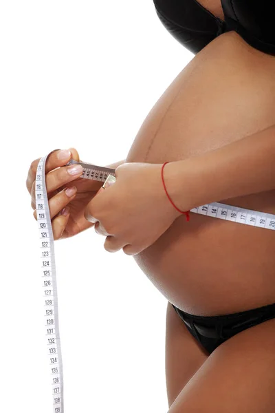 Pregnant woman measuring her belly. — Stock Photo, Image