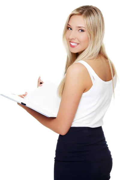 Portrait of beautiful young student girl holding notebook. Stock Picture