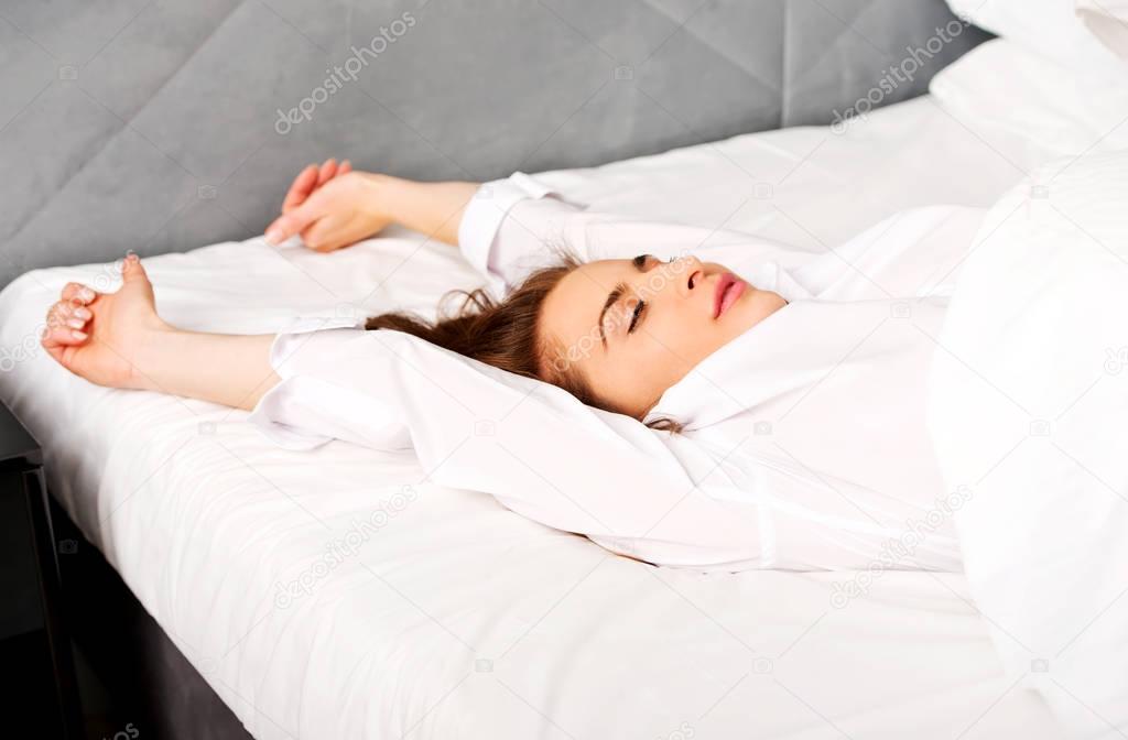 Woman stretching in bed after wake up