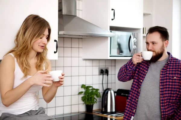 Young couple is drinking tea and coffee at home Stock Image