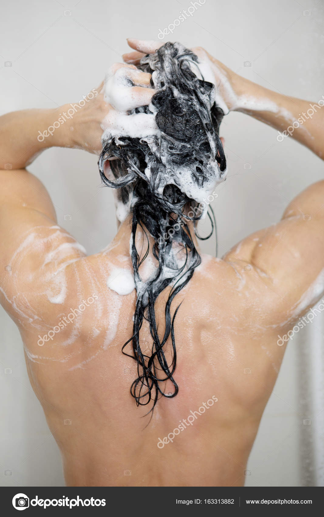 Fitness woman taking shower after work out. Stock Photo by