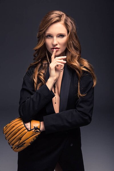 seductive woman with baseball mitt showing silence sign