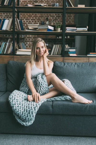 Young woman on sofa — Stock Photo