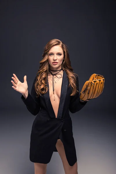 Sexy woman in black jacket posing with baseball mitt — Stock Photo