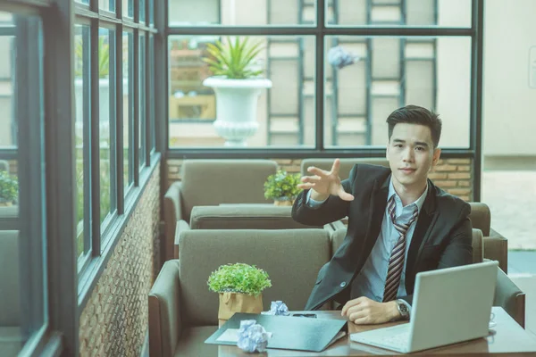 Angry senior businessman sitting at his desk and screaming, Angr