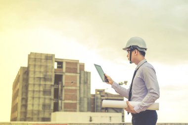 Gülümseyen genç mimar veya Oluşturucusu'nda kask ile mühendislik 