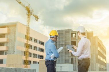 Gülümseyen genç mimar veya Oluşturucusu'nda kask ile mühendislik 