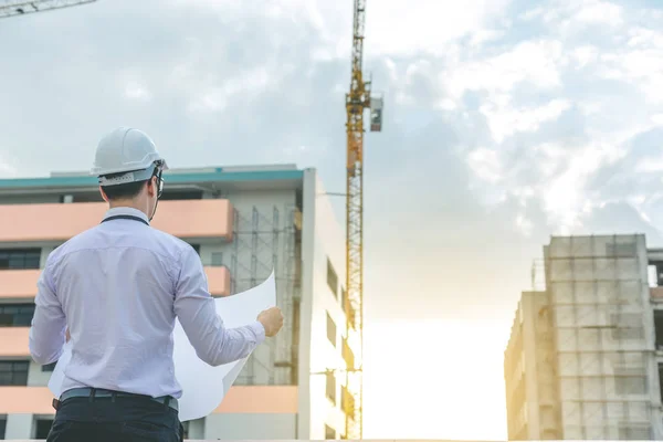 Jeune architecte souriant ou constructeur d'ingénierie en casque dur avec — Photo