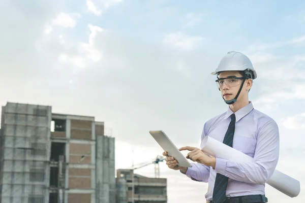 Jeune architecte souriant ou constructeur d'ingénierie en casque dur avec — Photo