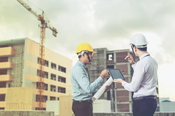 Jeune architecte souriant ou constructeur d'ingénierie en casque dur avec — Photo