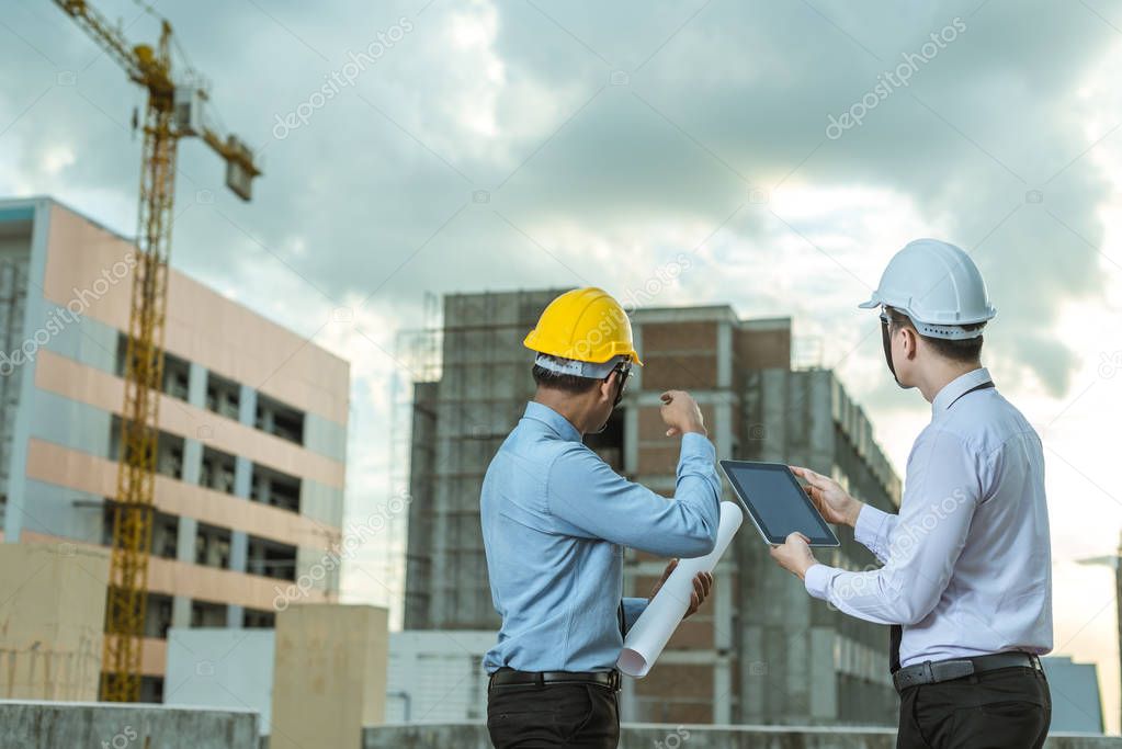smiling young architect or engineering builder in hard hat with 