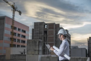 Gülümseyen genç mimar veya Oluşturucusu'nda kask ile mühendislik 