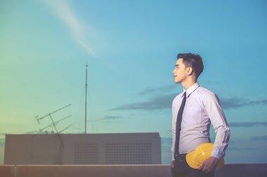 Gülümseyen genç mimar veya Oluşturucusu'nda kask ile mühendislik 