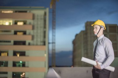 Gülümseyen genç mimar veya Oluşturucusu'nda kask ile mühendislik 