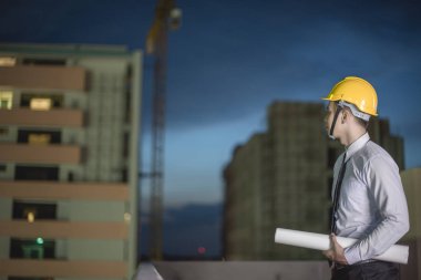 Gülümseyen genç mimar veya Oluşturucusu'nda kask ile mühendislik 