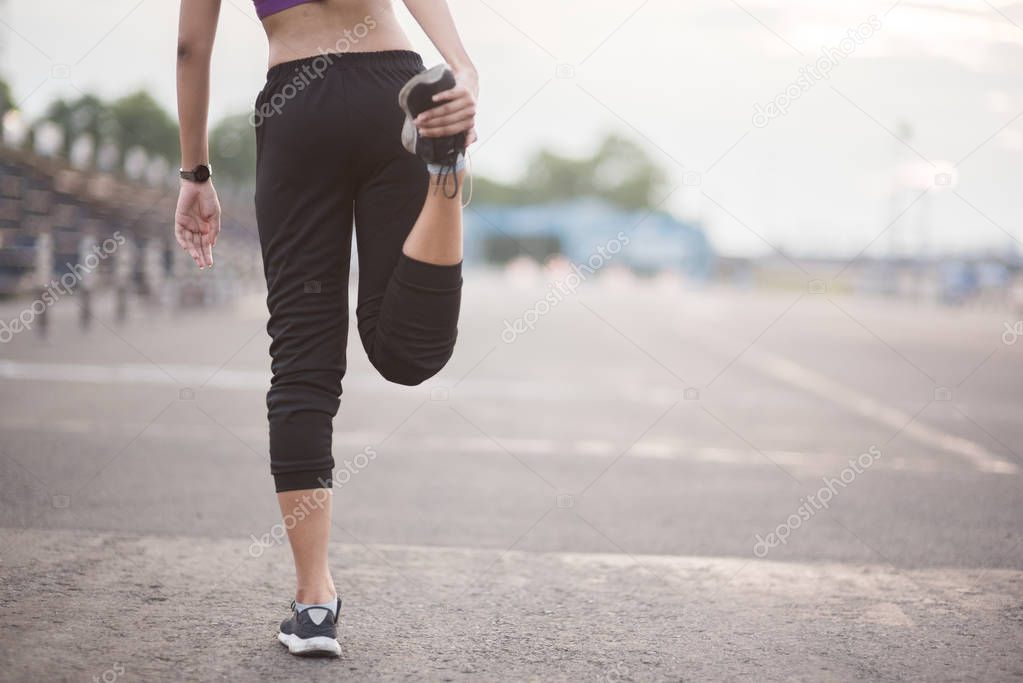 Smiling of Asia woman athlete sitting on an exercise mat and str