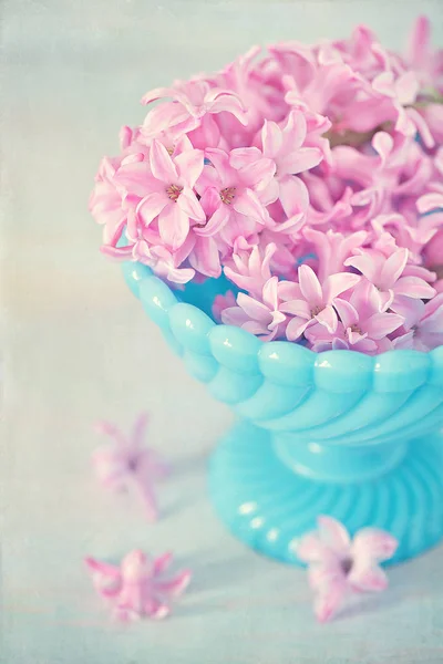 Pink hyacinths in a vase.