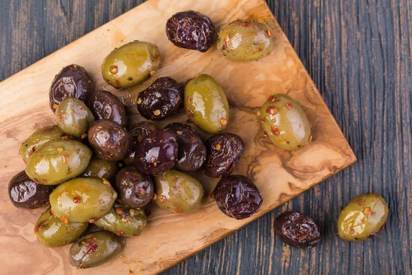 Olives on a wooden background — Stock Photo, Image