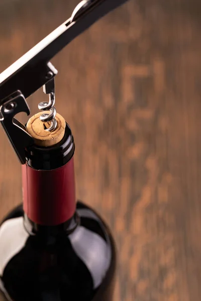 Corkscrew and bottle of wine — Stock Photo, Image