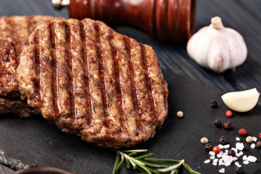 Fresh meat cutlets on wooden background