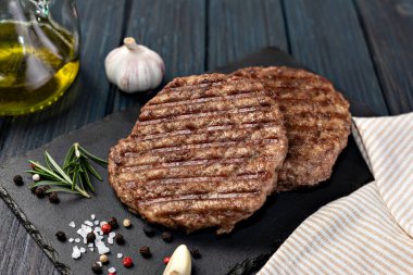 Fresh meat cutlets on wooden background
