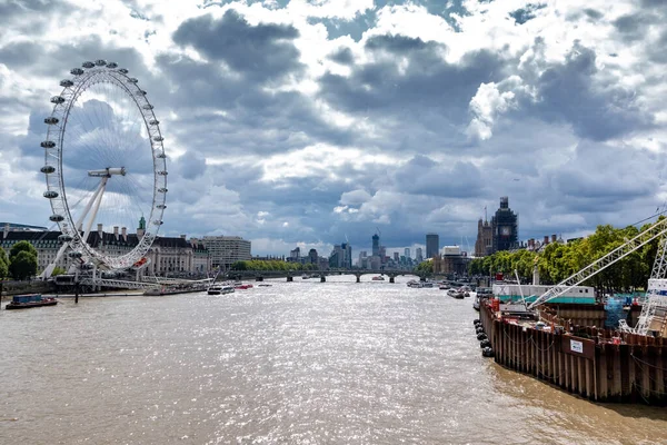 LONDON, İngiltere - 7 SEP 2019: Thames nehrinin manzarası. London Eye sol tarafta ve Big Ben sağ tarafta. Arka planda finans merkezi.