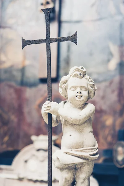 Close-up of white angel holding cross — Stock Photo, Image