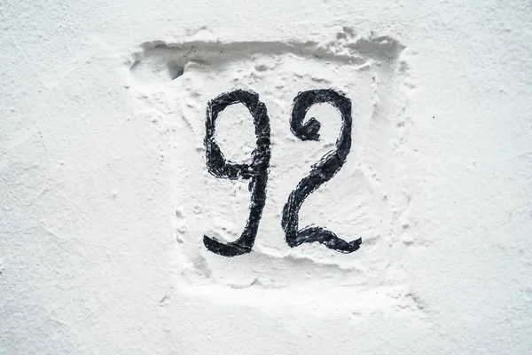92 número en la pared blanca —  Fotos de Stock