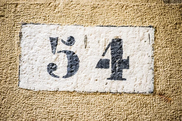 Números en muro de piedra —  Fotos de Stock