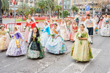 VALENCIA,SPAIN - MARCH 18: Several unidentified women walk in the offering of Fallas, one of the biggest parties in Spain on March 18,2016 in Valencia,Spain.