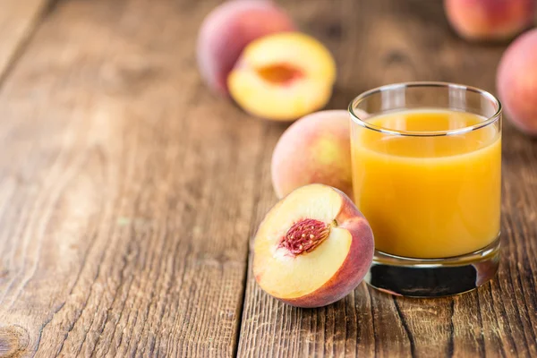 Peach juice on table — Stock Photo, Image