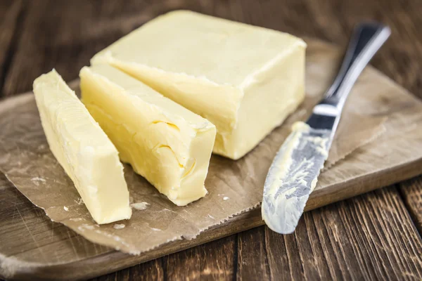 Pieces of Butter on wooden table — Stock Photo, Image