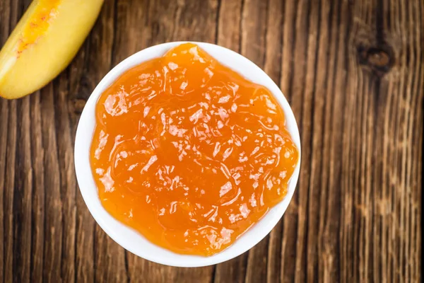 Wooden table with Peach Jam — Stock Photo, Image