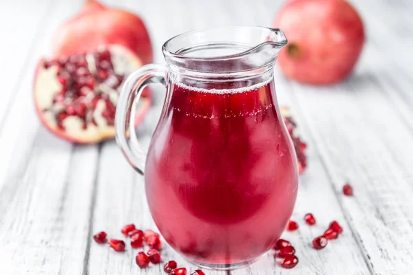 Pomegranate juice on table — Stock Photo, Image