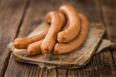 Sausages  on rustic wooden background  clipart