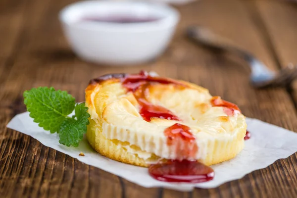 Cheesecake with Sauce on an old wooden table — Stock Photo, Image